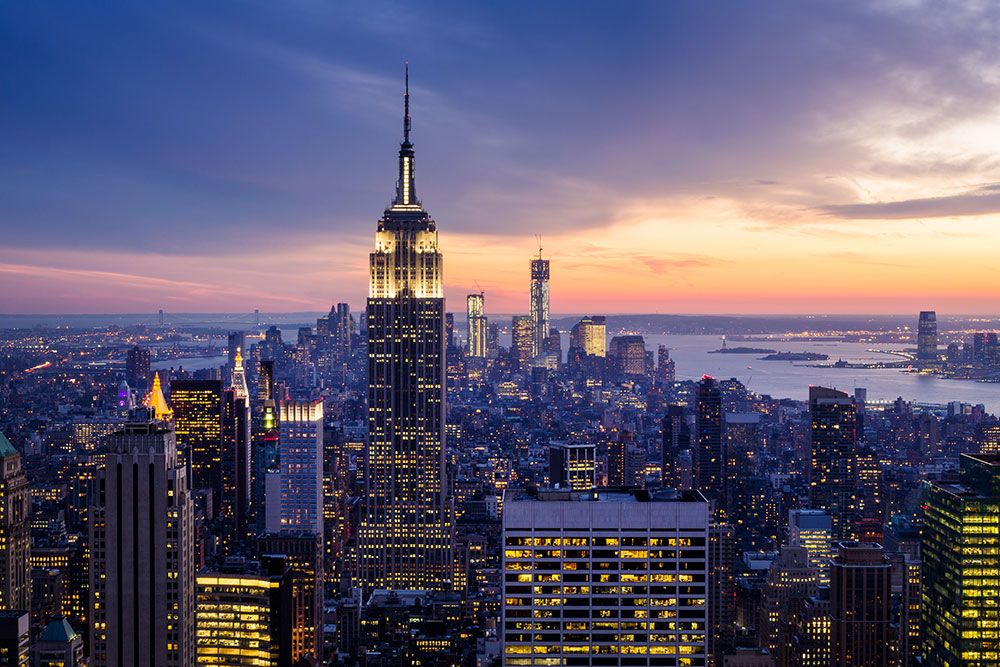 Aerial view of California City skyline at sunset with iconic skyscrapers and vibrant cityscape lighting.