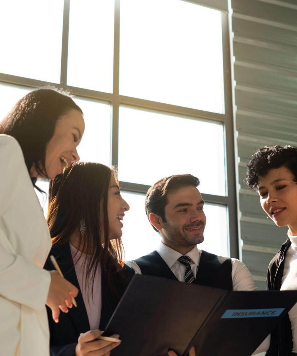 a group of business people standing around each other