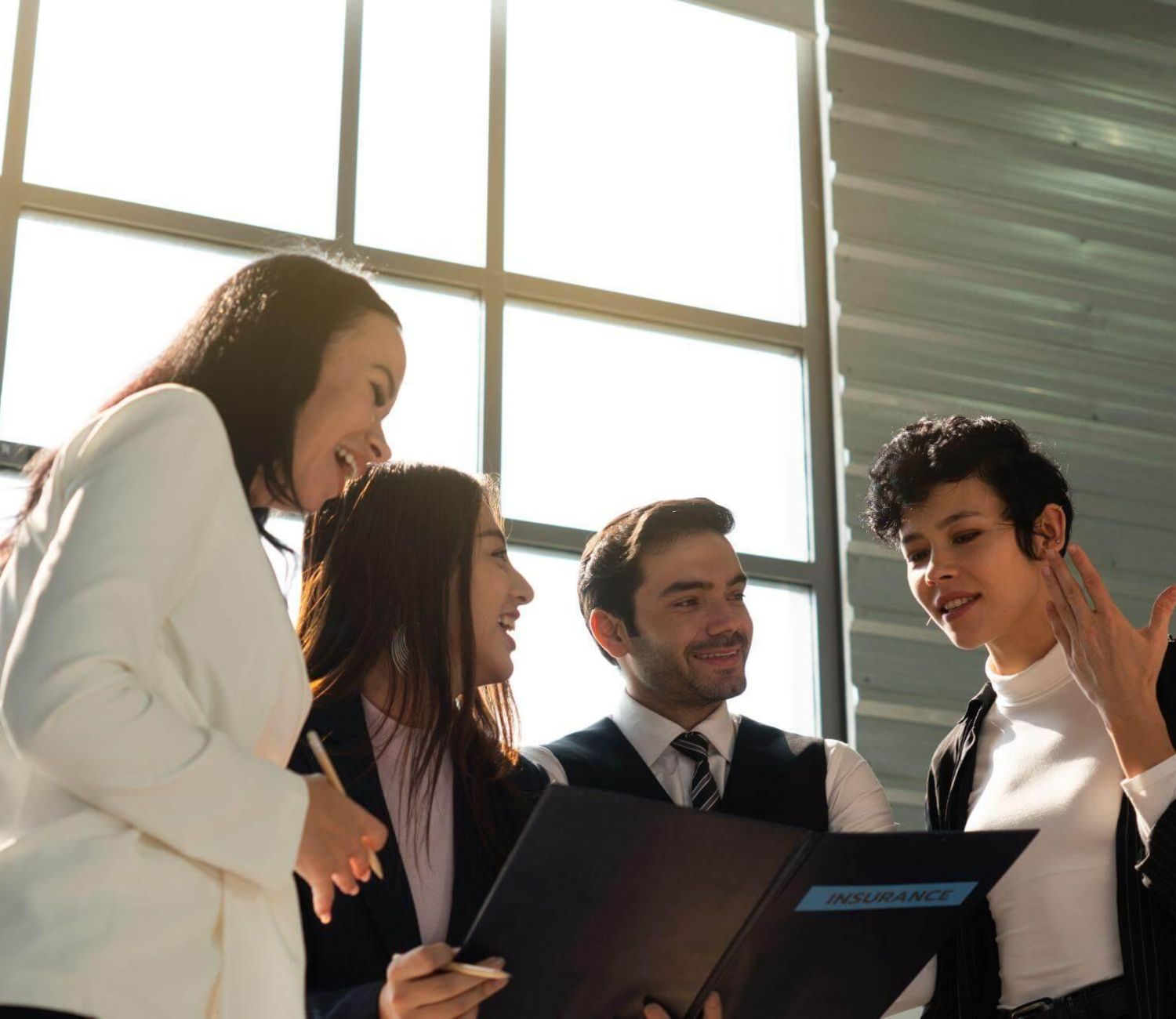 a group of business people standing around each other