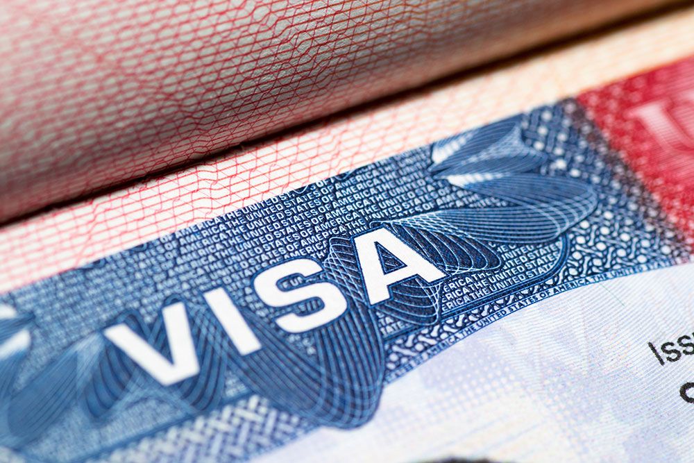 Close-up of a U.S. visa document with detailed security features and text.