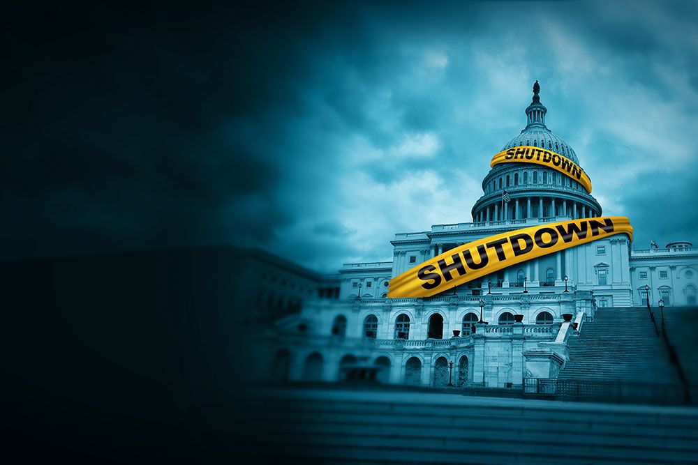 U.S. Capitol building with a shutdown banner, under dark clouds, symbolizing government closure.
