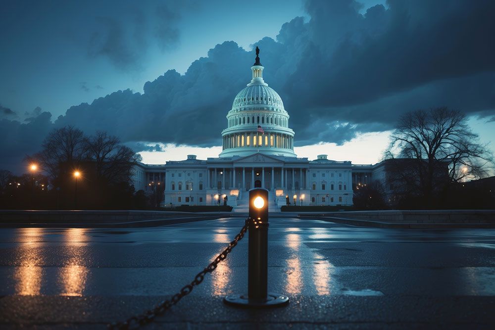 Capitol Building at dusk with dramatic clouds and streetlights illuminating the scene.