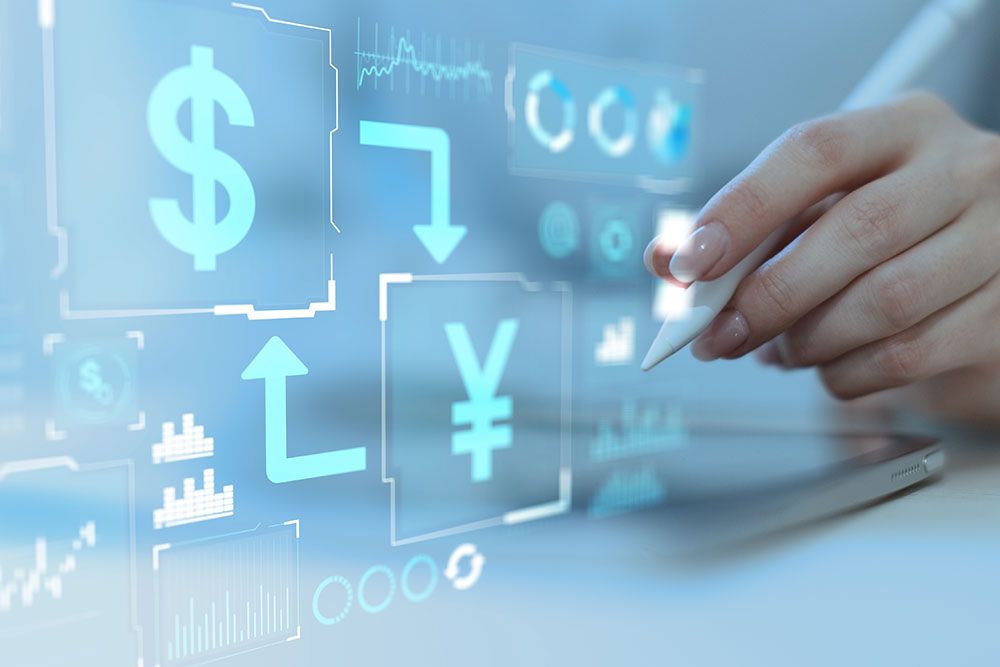 Touchscreen with currency symbols and graphs, hand holding stylus, digital financial interface concept.