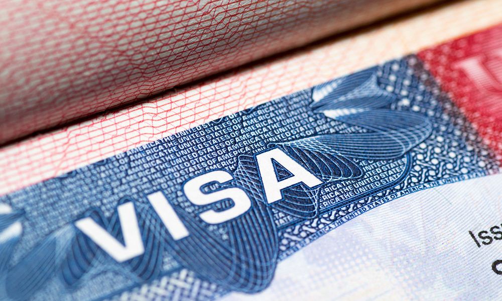 Close-up of a U.S. visa document with detailed security features and text.