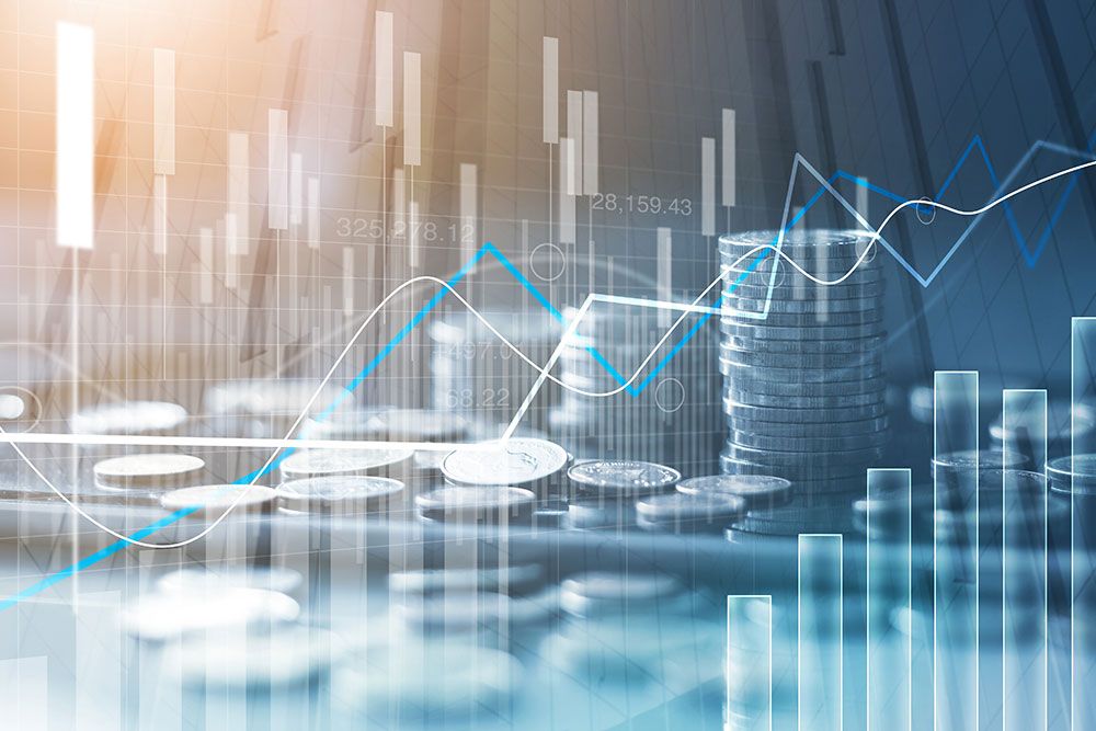 Stacked coins with financial charts, rising graph lines, and bar charts representing market growth and investment trends.