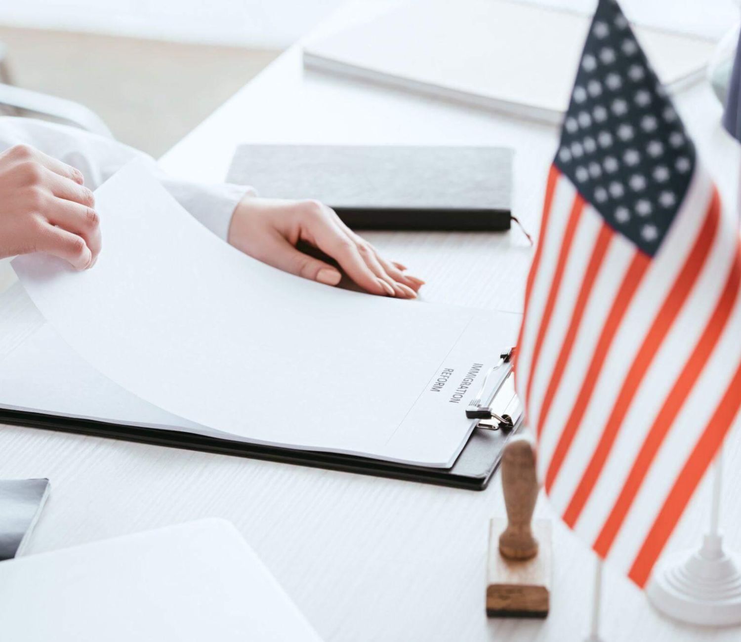 a person sitting at a desk with an american flag