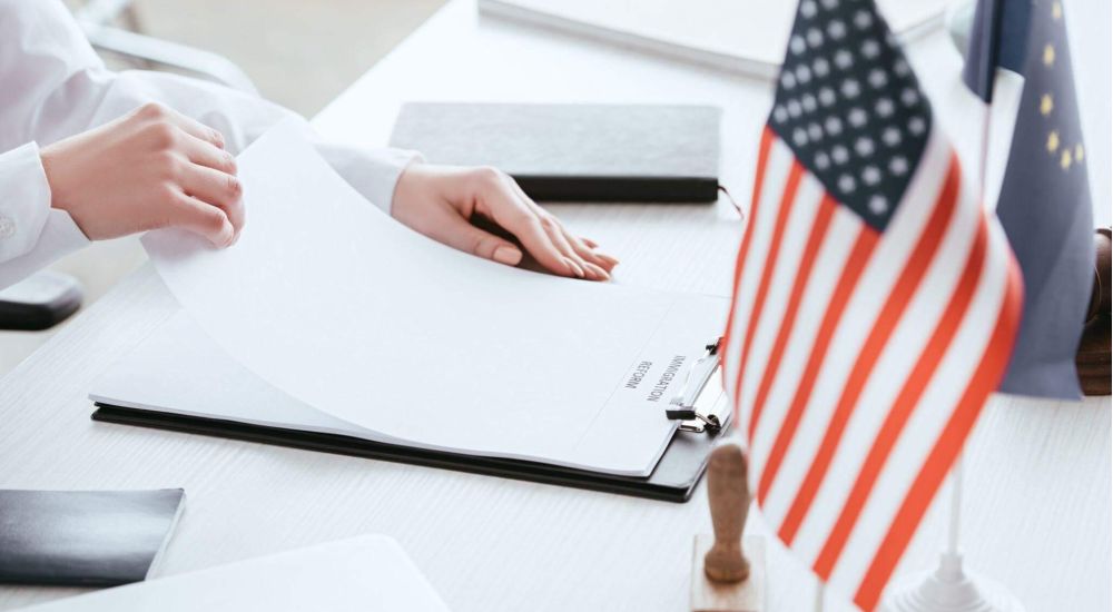 a person sitting at a desk with an american flag