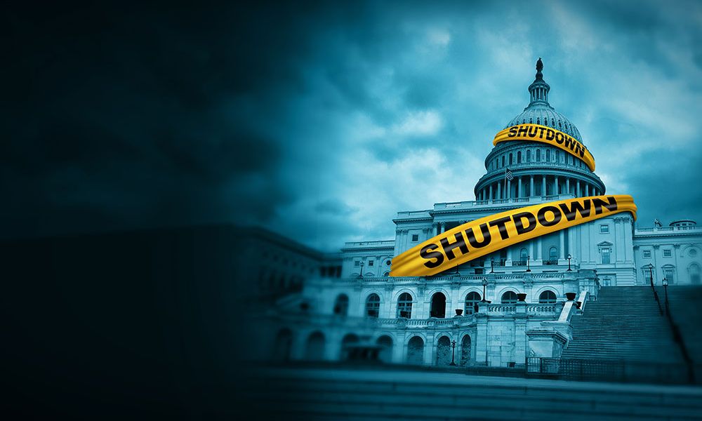 U.S. Capitol building with a shutdown banner, under dark clouds, symbolizing government closure.