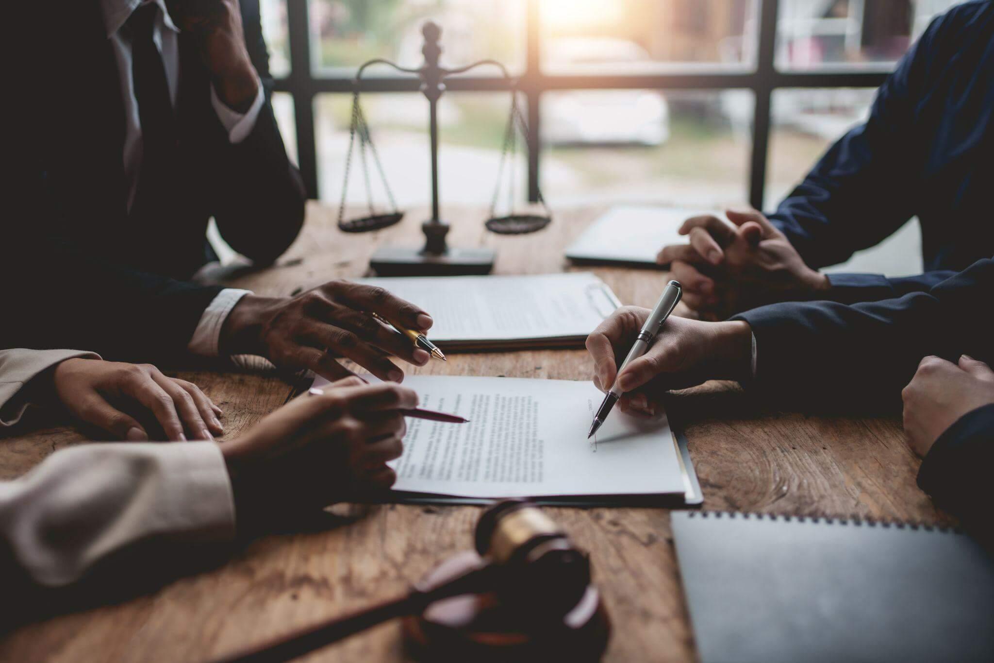 a group of people sitting around a wooden table