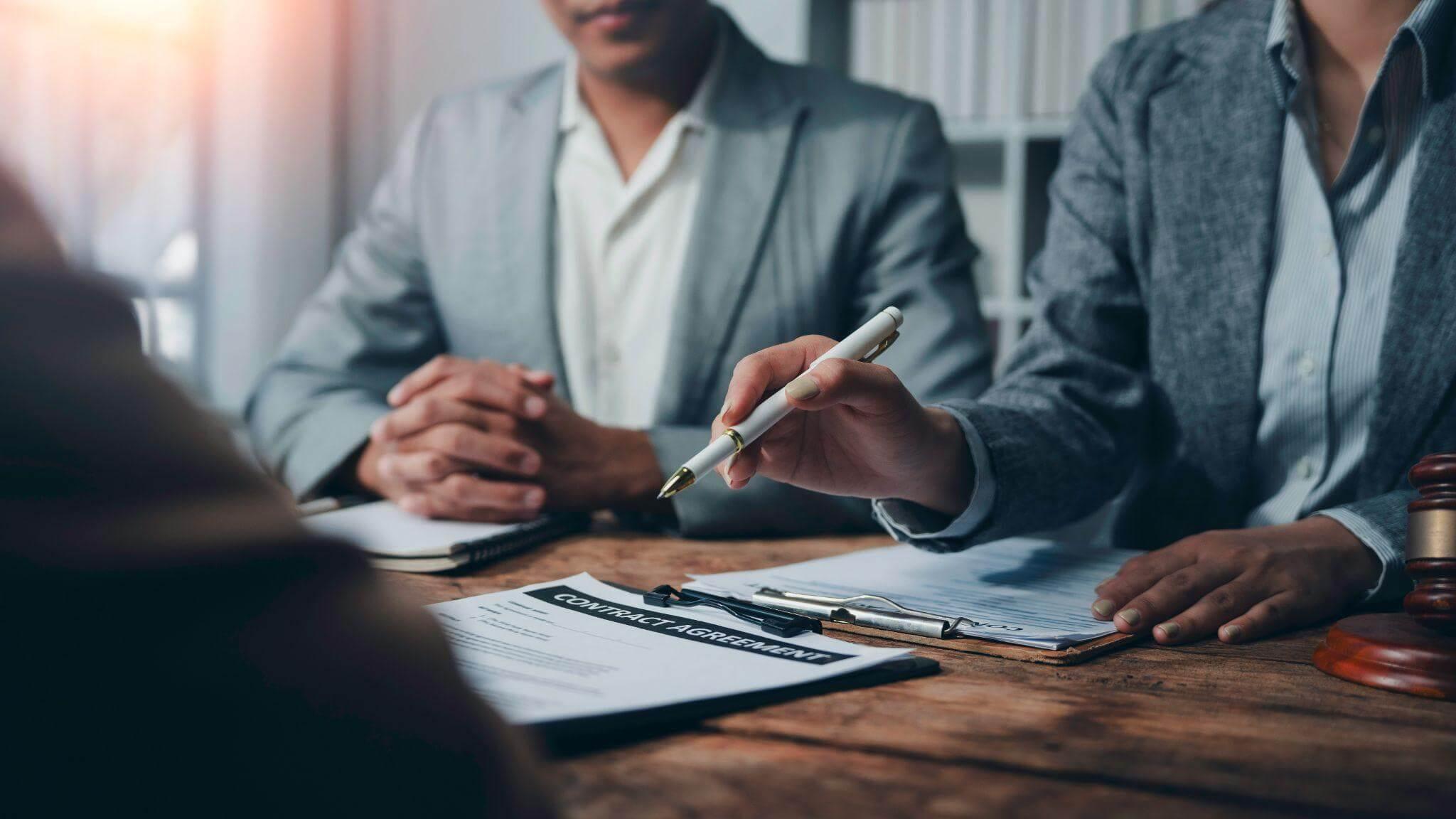 Two men reviewing documents for partnership dispute.